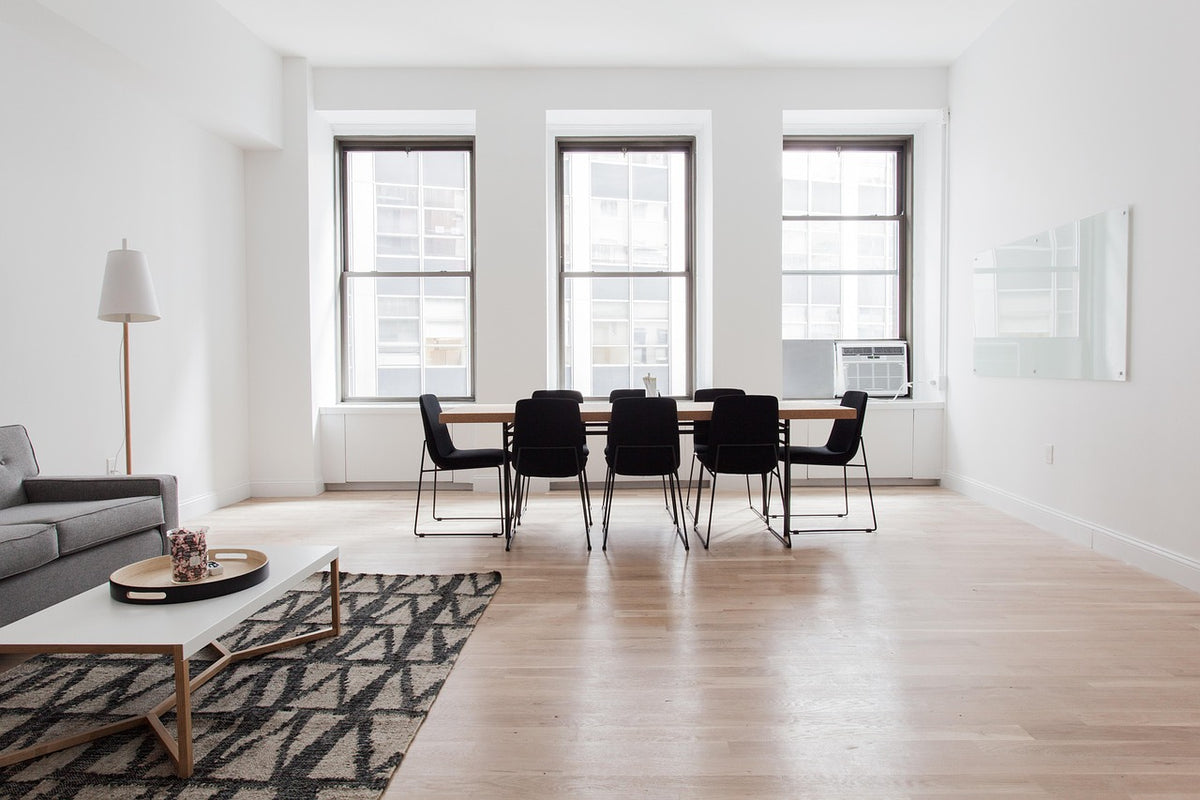 A floor lamp in a bright, minimal modern living space
