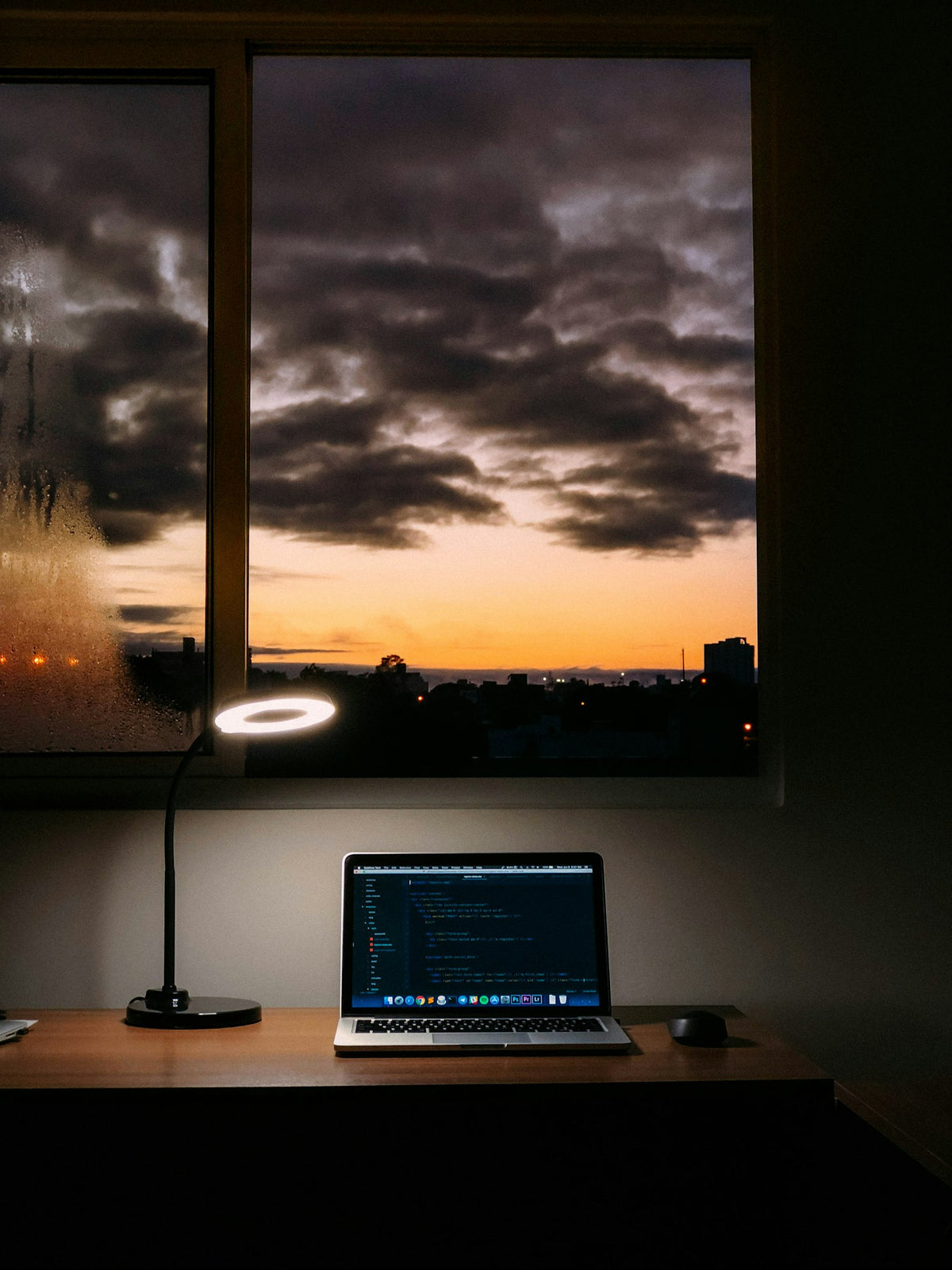 Laptop on a tidy desk beside a window with natural light