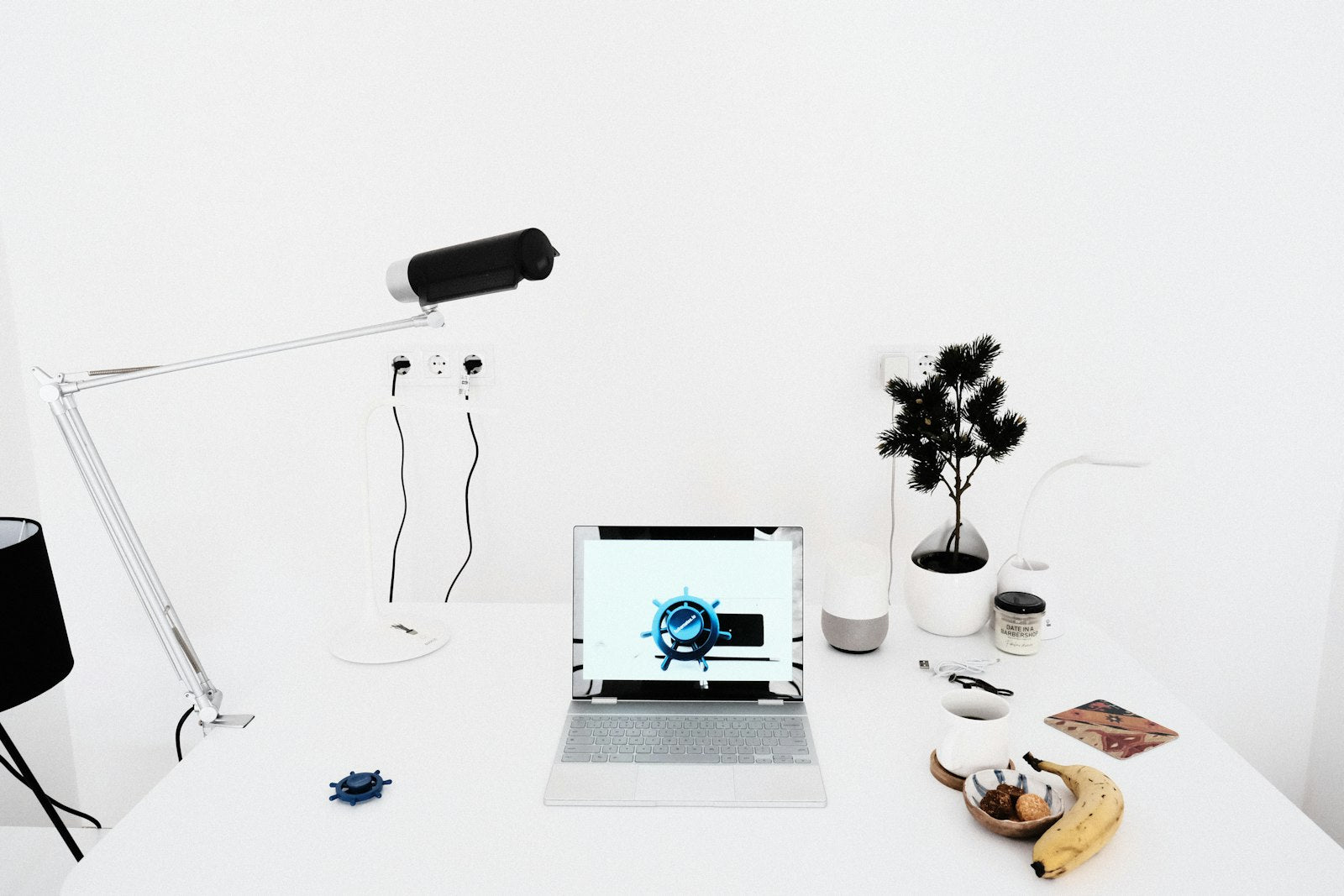 Laptop on a clean white desk with a clutter-free, cable-free surface