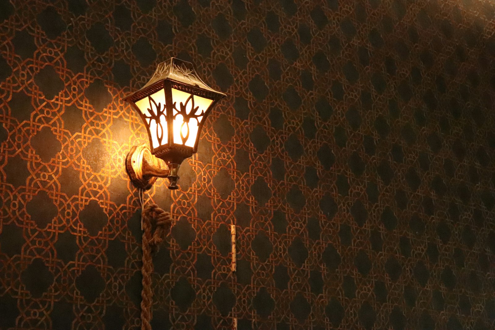 Warm wall sconce casting soft light on an interior wall