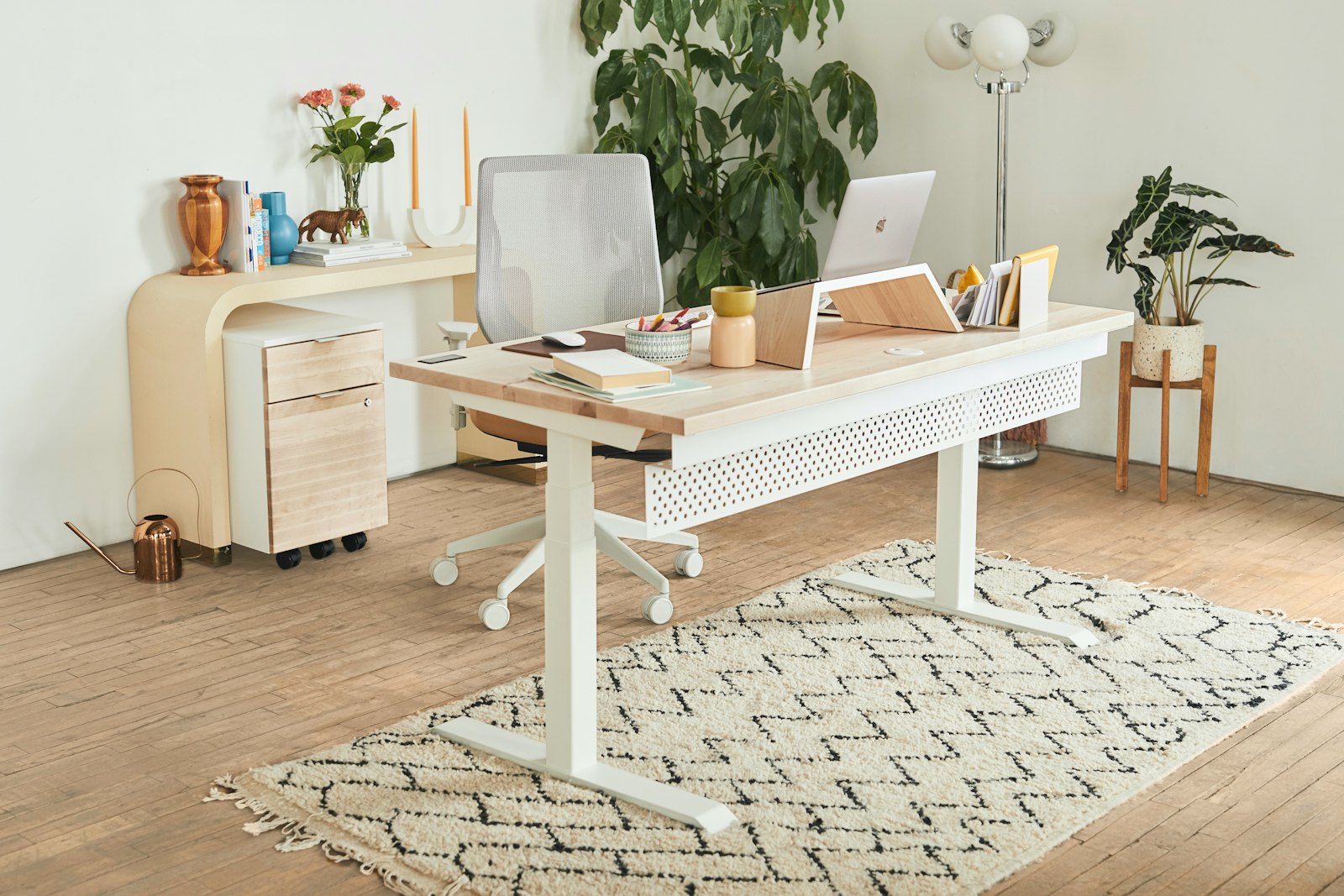 Clean white desk with a laptop and tidy, clutter-free surface