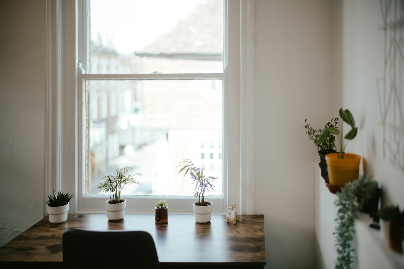 Desk and chair beside a window with soft natural light