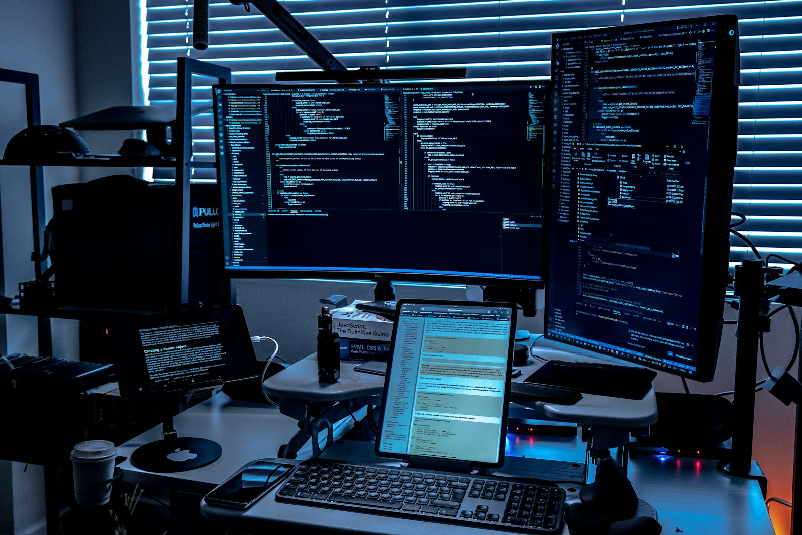 Desk with several monitors arranged in a multi screen workspace