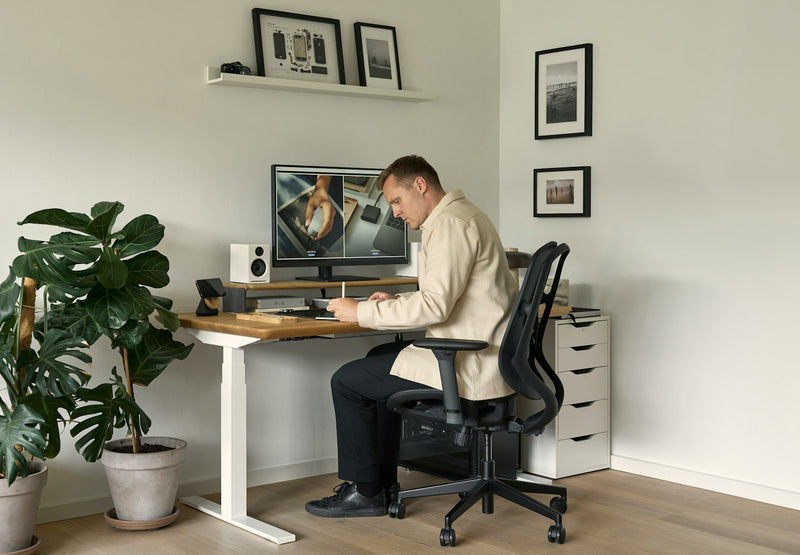 Person seated at a desk working at a computer in an office