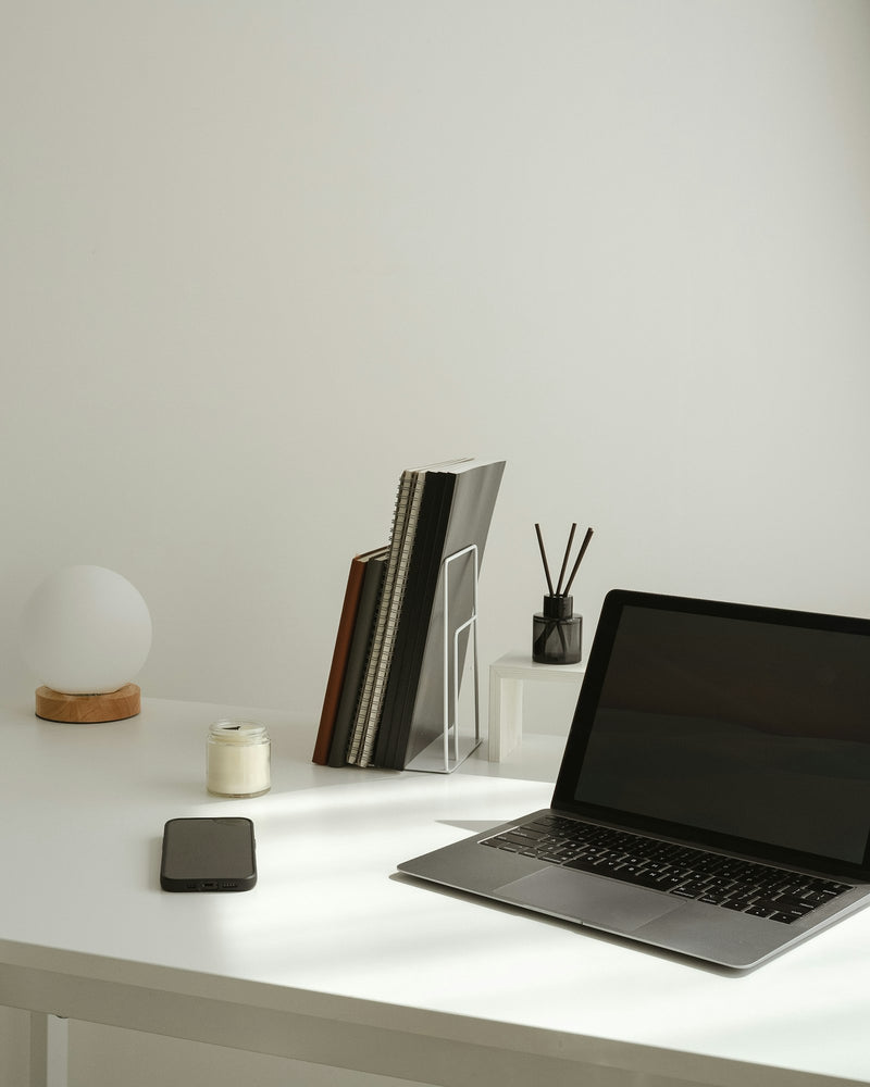 Minimal desk setup with a laptop and a few neatly arranged accessories