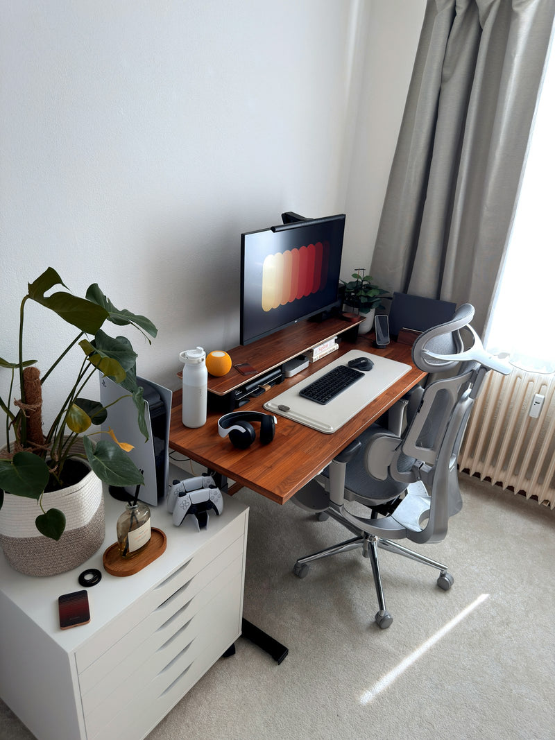 Modern home office with a clean desk and an ergonomic chair in natural light