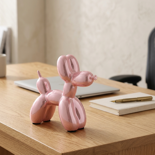 Ceramic Balloon Dog Sculpture, pink in a workspace