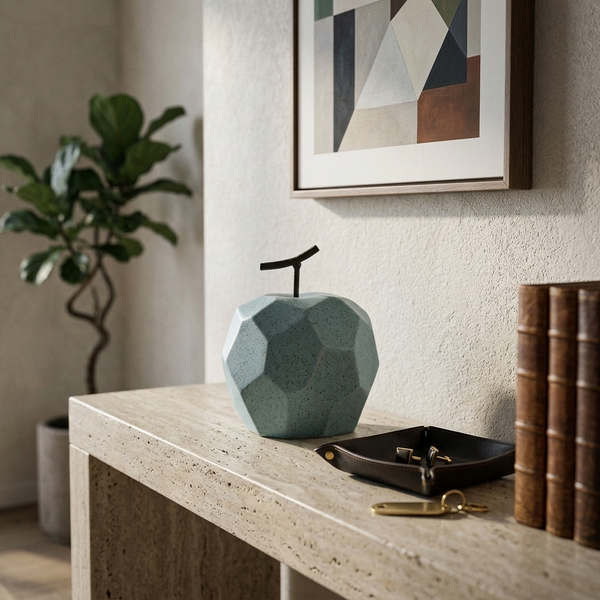 Faceted Porcelain Apple Sculpture, blue in a workspace
