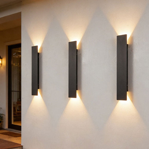 Beacon outdoors, three lights in a row on a rendered exterior wall