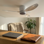White flush-mount ceiling fan in a bright home office