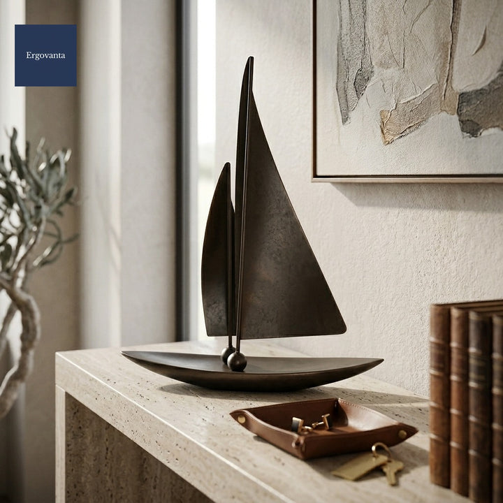 Patinated bronze sailing yacht sculpture on an executive entryway travertine console