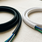 Black and white woven cable sleeves shown side by side to compare the two color choices