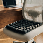 Ergovanta Air-Cell Seat Cushion in Black on a modern office chair