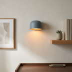 Glazed dome sconce on a workspace wall