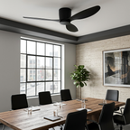 All-black flush-mount ceiling fan above a corporate meeting room
