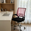 Pink mesh task chair at a white home office desk